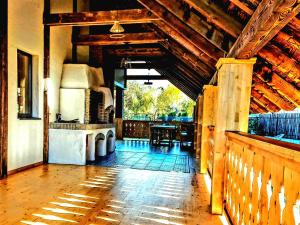 a living room with a wooden ceiling and a table at Cuibul Braneanului in Bran