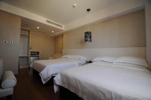 Krevet ili kreveti u jedinici u okviru objekta The Riverside Hotel Hengchun