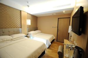 Krevet ili kreveti u jedinici u okviru objekta The Riverside Hotel Hengchun