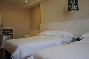 Krevet ili kreveti u jedinici u okviru objekta The Riverside Hotel Hengchun