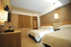 Krevet ili kreveti u jedinici u okviru objekta The Riverside Hotel Hengchun