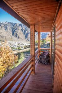 a porch of a cabin with a view of the mountains at My Space Kazbegi in Stepantsminda