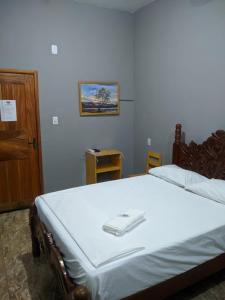 a bedroom with a large bed with a white blanket at Mapará Beach hotel-Baião-Pará in Baião