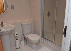a bathroom with a toilet and a sink and a shower at Trendy city centre apartment with free parking in Cardiff