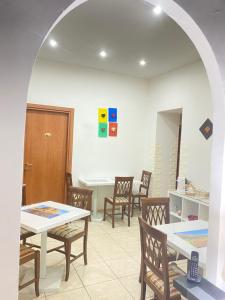 a dining room with tables and chairs in a room at B&B Dimora Cirillo in Naples