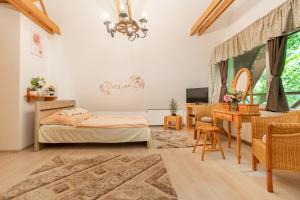 A bed or beds in a room at Csodaszarvas Vendégház