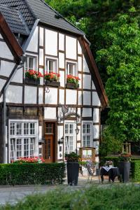 a house with flowerpots on the windows of it at Hotel Alt Vellern in Beckum