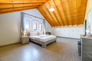 a bedroom with a bed and a wooden ceiling at Villa Olivia in Xylophaghou +11 photos