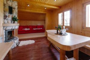 a living room with a table and a fireplace at Chalet Orlica Velika Planina in Stahovica