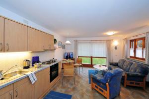 a kitchen and living room with a couch and a table at Ferienwohnung Vogl in Berchtesgaden +6 photos