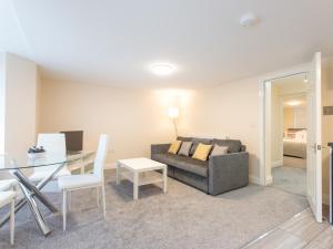 a living room with a couch and a table at Dartford Luxurious Apartment in Dartford