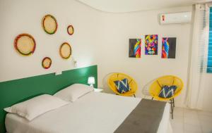 Un pat sau paturi într-o cameră la Pousada Serra Bella