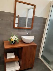 a bathroom with a sink and a mirror at Cosy and Charming Home 2 in Antananarivo