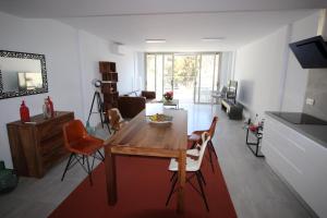 a living room with a wooden table and chairs at SUN, SEA AND ROCKS in Puerto de Mogán