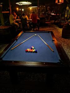 a pool table with cue balls on top of it at La Brújula Hostel in La Paloma