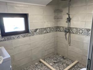 a shower with a window in a bathroom at Guest House Malusha in Gabrovo +32 photos