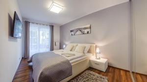 Postel nebo postele na pokoji v ubytování Polanki z sauną, Sun & Snow