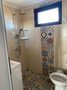 a bathroom with a shower and a toilet at Guest House Malusha in Gabrovo