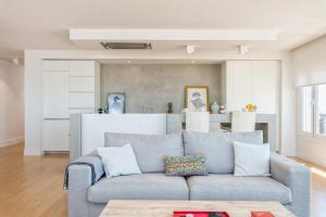 un soggiorno con divano blu e una cucina di Solaga - Linaje a Málaga