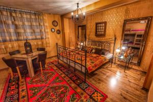 1 dormitorio con cama, mesa y alfombra en Pansion Bubamara Mostar, en Mostar