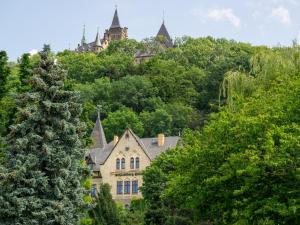 an old house in the midst of trees at Schlossberg-Hotel Garni in Wernigerode