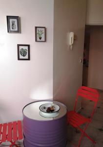 a table with a plate of food and a red chair at LAU 08 Appart Agdal 80m2 in Rabat