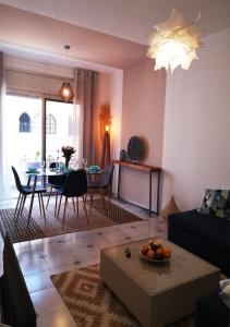 uma sala de estar com um sofá e uma mesa em LAU 08 Appart Agdal 80m2 em Rabat
