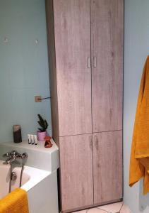 a bathroom with a large wooden cabinet next to a sink at LAU 08 Appart Agdal 80m2 in Rabat