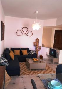 a living room with a couch and a table at LAU 08 Appart Agdal 80m2 in Rabat