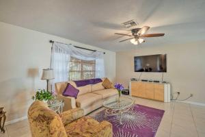 a living room with a couch and a ceiling fan at Marco Island Retreat with Pool about 1 Mi to Beach in Marco Island