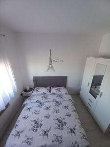 a bedroom with a bed with a dresser and a tower at Apartman Panorama in Kupres