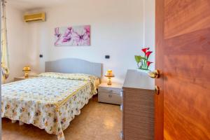 a small bedroom with a bed and a dresser at Adriatico apartment in Alghero