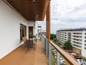 a balcony with chairs and a table on a building at VacationClub - Olympic Park Apartament C602 in Kołobrzeg