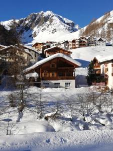 a building in the snow in front of a mountain at Casa Carinthia in Samnaun