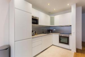 - une cuisine blanche avec des armoires et des appareils blancs dans l'établissement Appartement8P/Full Equipped/BONNE NOUVELLE/BOURSE, à Paris