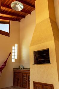 a living room with a stone fireplace in a house at Chale c piscina e churrasqueira em Sao Leopoldo-RS in São Leopoldo