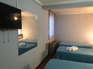 Cama ou camas em um quarto em Palace Hotel Mendoza