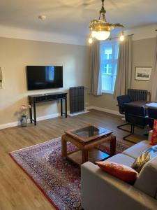 a living room with a couch and a table at Apartments im Kaffeehaus Heldt in Eckernförde