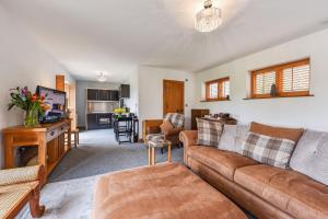 a living room with a couch and a tv at Crabden Meadows, Blendworth in Horndean