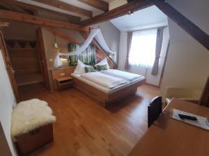 a small bedroom with a bed and a window at Gasthaus & Hotel Drei Lilien in Werbach
