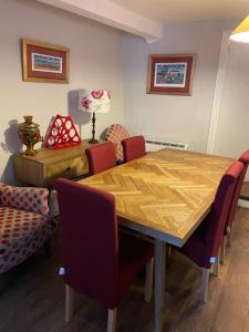 a dining room with a wooden table and chairs at The Bittern in Blakeney