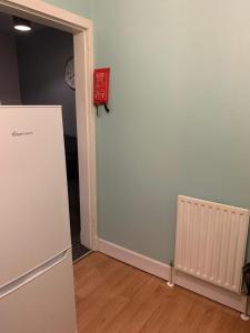 an empty room with a door and a radiator at Town Centre Kilmarnock in Kilmarnock