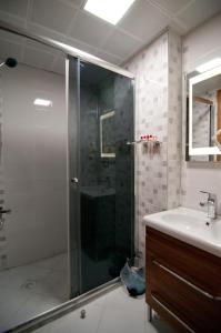 a bathroom with a shower and a sink at Mus Grand Hotel in Muş