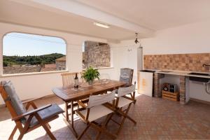 a dining room with a wooden table and chairs at Luxury 3 Bedroom Apartment in Vrsar