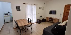 a living room with a table and a couch at Departamento en complejo residencial Villa Maria in Villa María