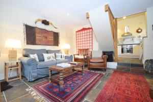 a living room with a couch and a table at The Barn at Guiles , Petersfield in Petersfield