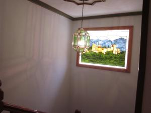 
a room with a window and a clock on the wall at Hotel Elena María in Granada
