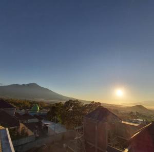 a view of the sun setting over a city at VILLA BATU 3F in Batu +6 photos