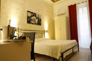 a bedroom with a bed and a blender on a table at B&B Liberty 900 in Catania