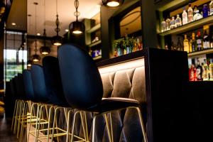a bar with a lot of chairs and tables at Motel One Paris-Porte Dorée in Paris
